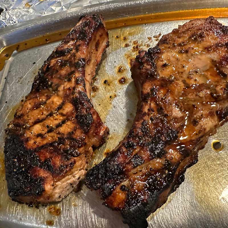 Sugar Pit Iberico pork chop resting on a carving tray
