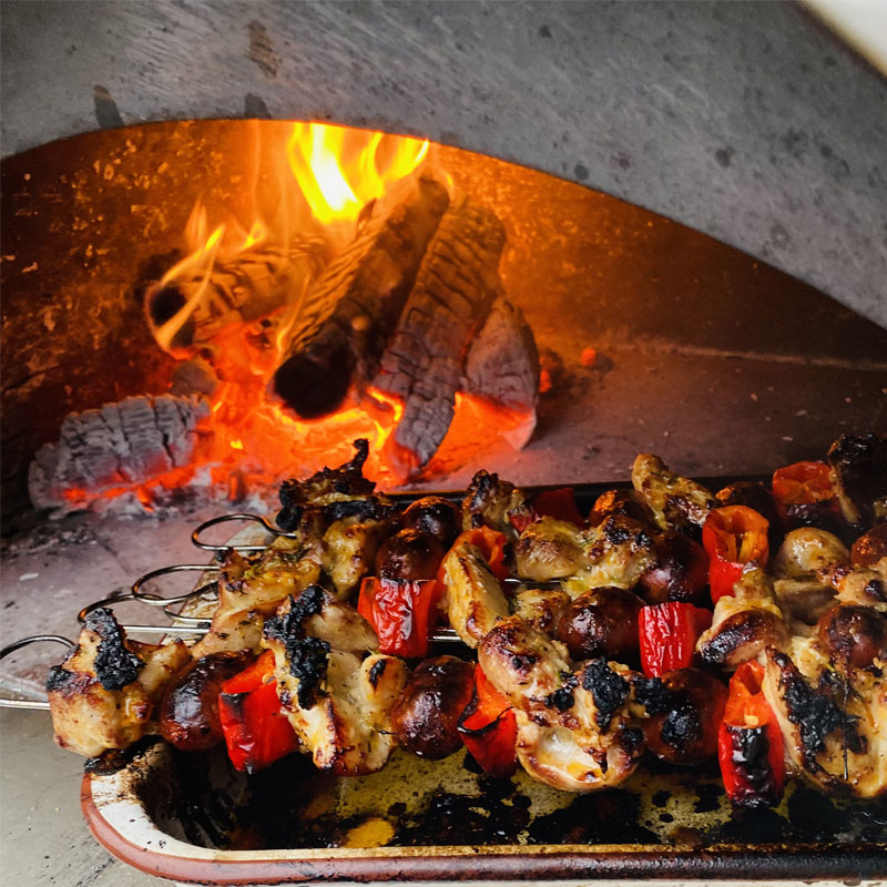 Chicken kebabs cooking over fire