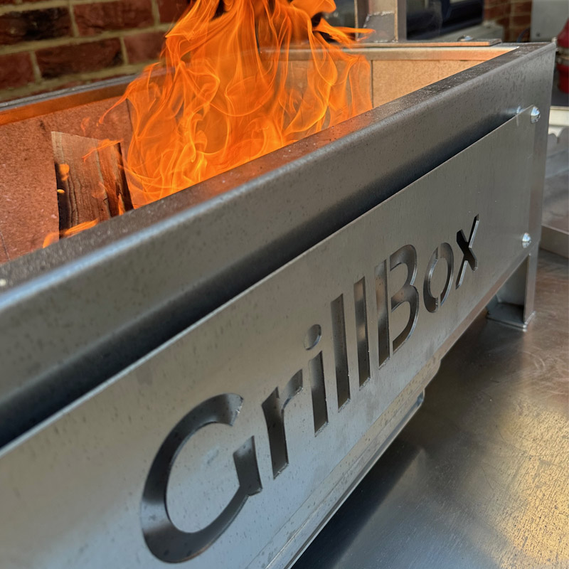 Flames and charcoal cooking on the GrillBox